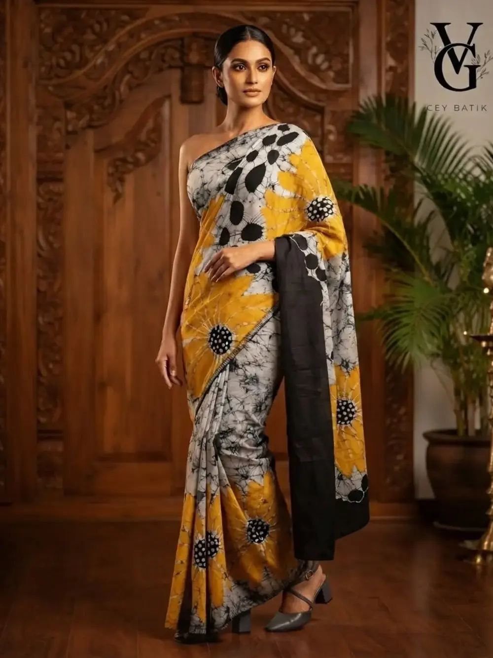 Model wearing a handcrafted yellow, white and black VG Ceybatik saree