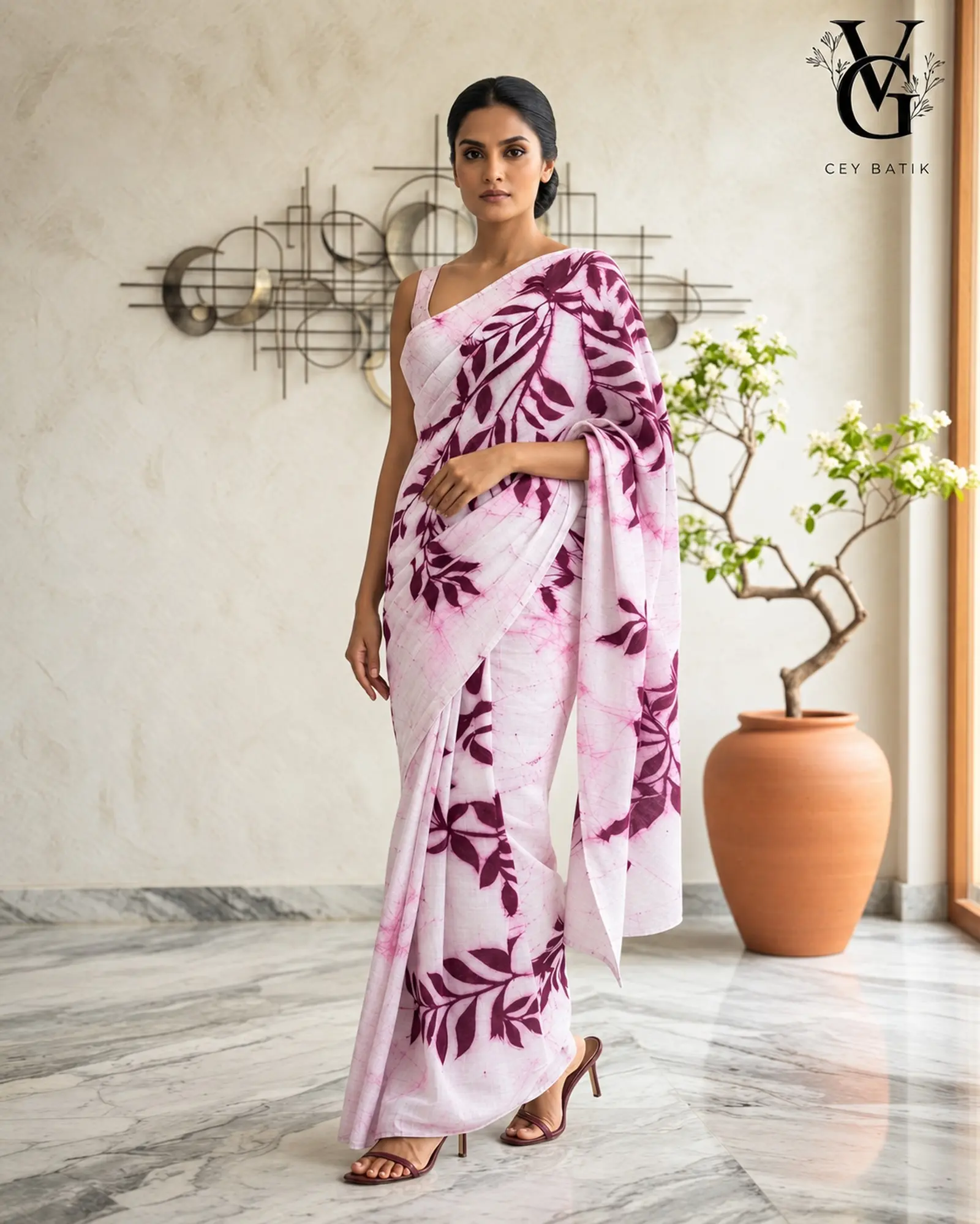 Woman wearing a pale pink and deep plum handmade batik saree by VG Ceybatik